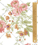 A close-up of a floral pattern featuring pink and orange flowers with green leaves on a white background, with a wooden ruler along the right side for scale.