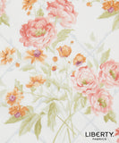 Liberty Fabrics floral pattern featuring large pink peonies, orange wildflowers, and green leaves on a white background with a faint blue grid.