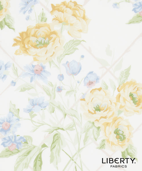 Liberty Fabrics floral pattern featuring large pale yellow peonies and light blue flowers with green leaves on a white background.