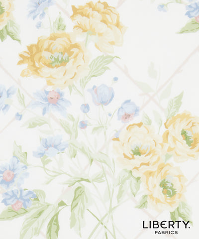 Liberty Fabrics floral pattern featuring large pale yellow peonies and light blue flowers with green leaves on a white background.