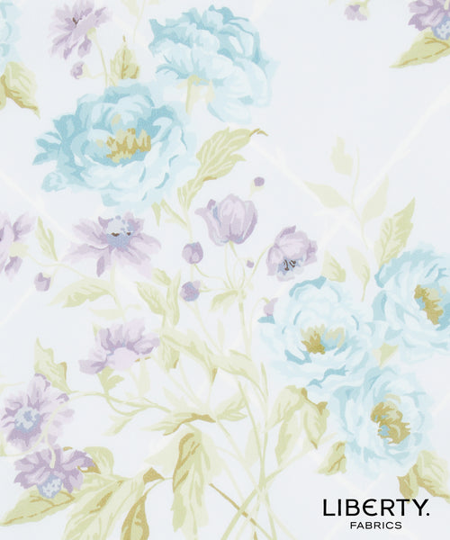 Liberty Fabrics floral pattern featuring light blue and lavender peonies with pale green leaves on a white background, with the 'LIBERTY. FABRICS' logo in the bottom right corner.