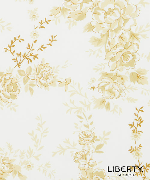 Liberty Fabrics floral patterned fabric featuring large cream and pale yellow flowers with gold outlines on a white background.
