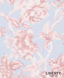 A close-up of a floral fabric pattern featuring pale pink peony-like flowers and leaves on a light blue background, with the text 'LIBERTY. FABRICS' in the lower right corner.