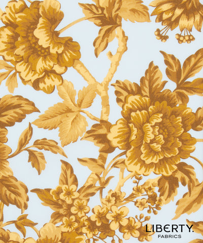 Liberty Fabrics floral pattern featuring large golden-yellow peony flowers and leaves on a light blue background, with the Liberty Fabrics logo in the bottom right corner.