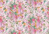 A repeating floral pattern featuring pink, purple, orange, and teal flowers with green leaves on a pale pink background.