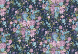 A dense floral pattern featuring pink, light blue, and purple flowers with green leaves on a dark navy blue background.