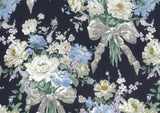 A close-up of a floral fabric pattern featuring large white and light blue flowers with silver-gray ribbon bows on a very dark navy or black background.