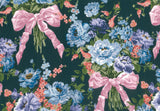 A close-up of a floral fabric pattern featuring bouquets of blue, purple, and pink flowers tied with large pink satin bows on a dark green background.