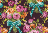 A close-up of a floral fabric pattern featuring large bouquets of pink, orange, and purple flowers tied with shiny teal ribbons on a dark plum background.