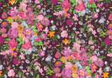 A dense floral pattern featuring pink, magenta, orange, and light blue flowers with green leaves on a dark plum-purple background.
