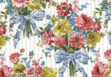 A repeating floral pattern featuring bouquets of red, yellow, and blue flowers tied with light blue satin bows, set against a white background with thin vertical gray lines.