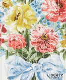 Liberty Fabrics floral print fabric featuring a bouquet of red, yellow, and pink flowers with green leaves and a light blue ribbon, shown with a vertical striped overlay.