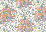A repeating watercolor floral pattern with pink, purple, blue, yellow, and green blossoms and leaves on a white background.