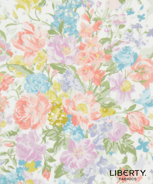 A close-up of a Liberty Fabrics floral pattern featuring watercolor-style flowers in pink, peach, purple, blue, yellow, and green on a white background, with the Liberty Fabrics logo in the bottom right corner.