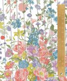 A close-up of a floral fabric pattern with pink, blue, purple, yellow, and green flowers on a white background, overlaid with vertical gray stripes. A wooden ruler is placed along the right edge for scale.